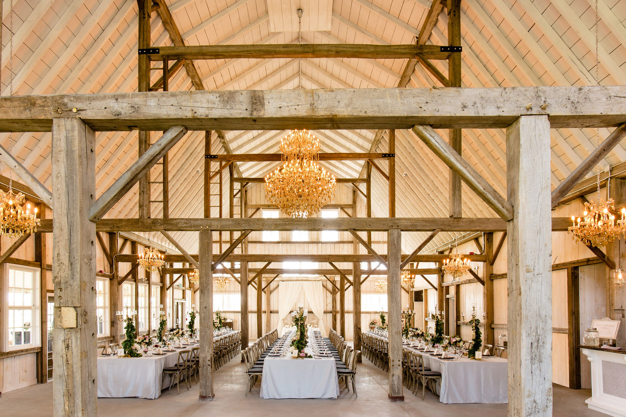 Photograph of French country-inspired barn decorated for a wedding reception at Stonefields Estate near Ottawa