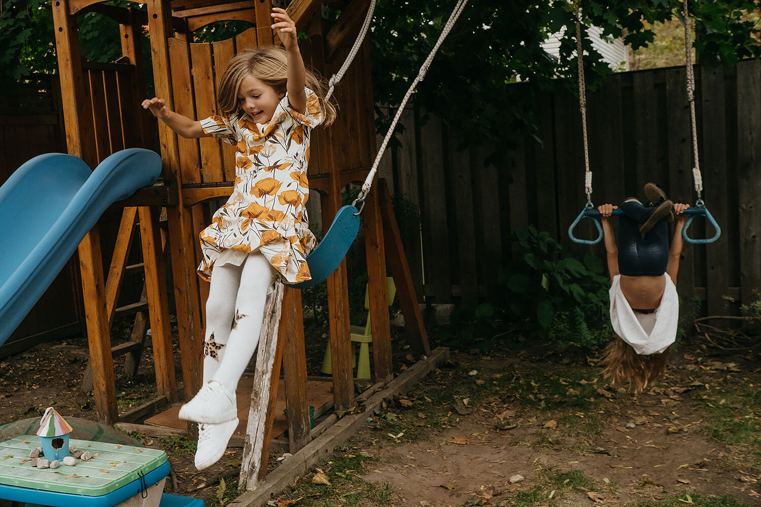 action photo of a girl jumping off a swing at an ottawa family photo session