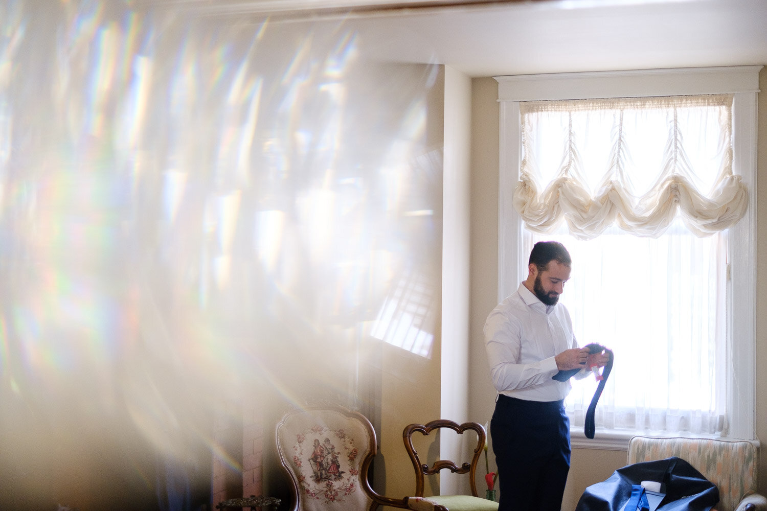 photograph of a groom getting ready