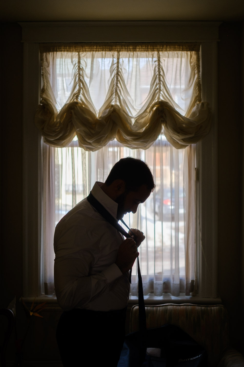 photograph of a groom getting ready