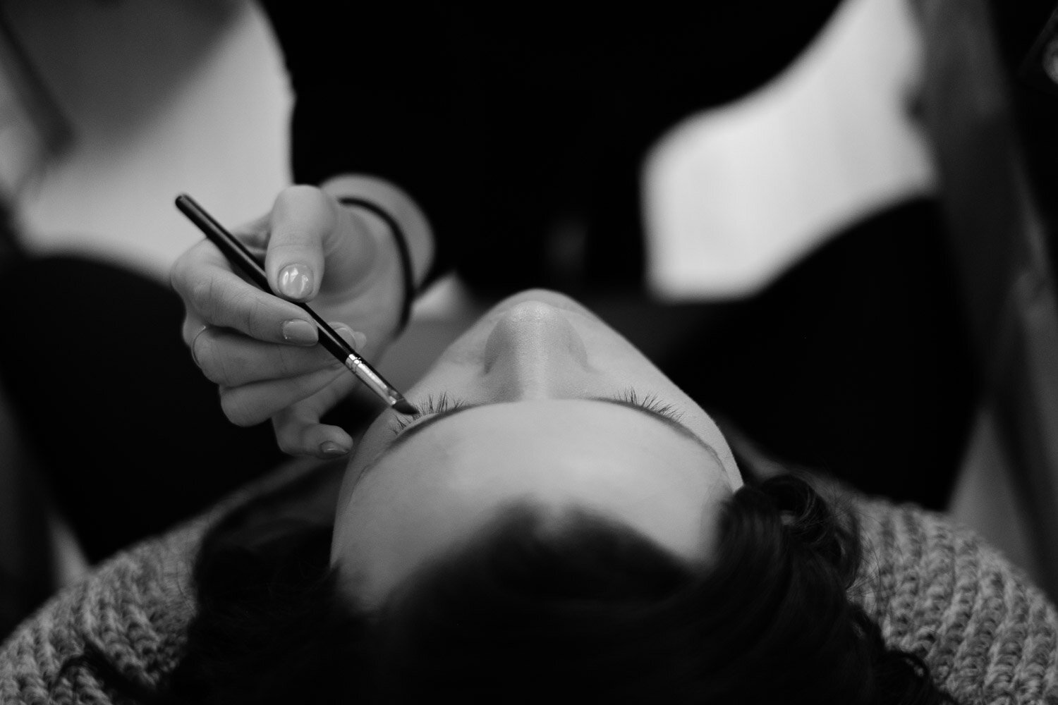 photo of a bride getting her makeup done before her wedding ceremony