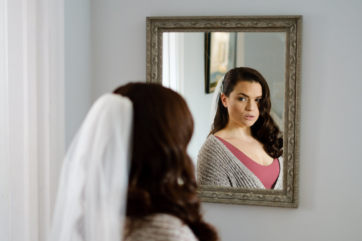 photograph of a bride looking in a mirror