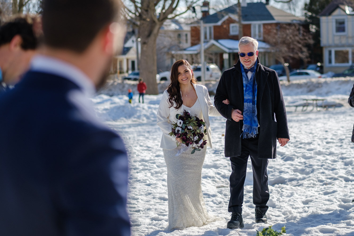 photograph of a bride walking down the aisle at her ottawa winter wedding