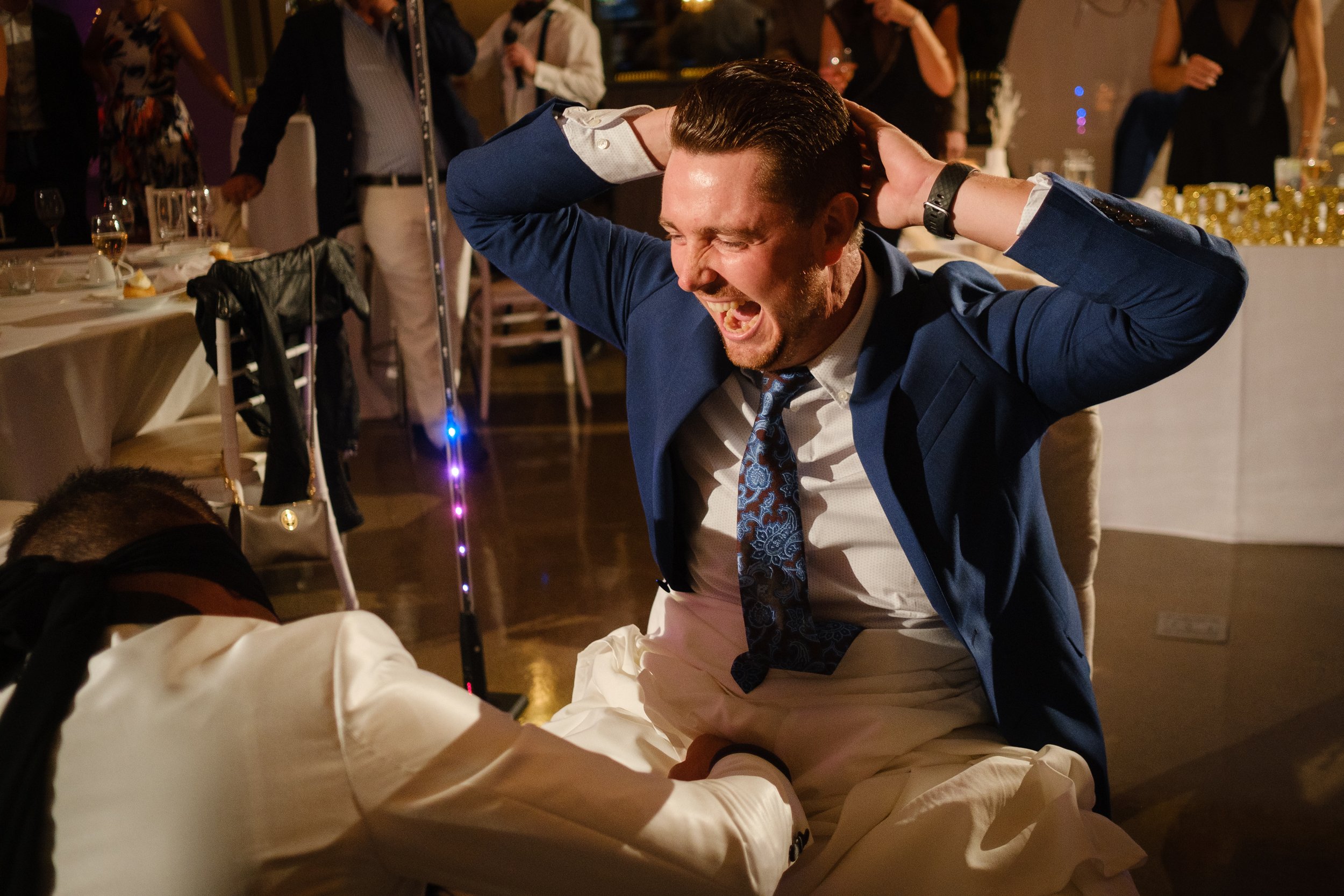 groom gets tricked during the garter