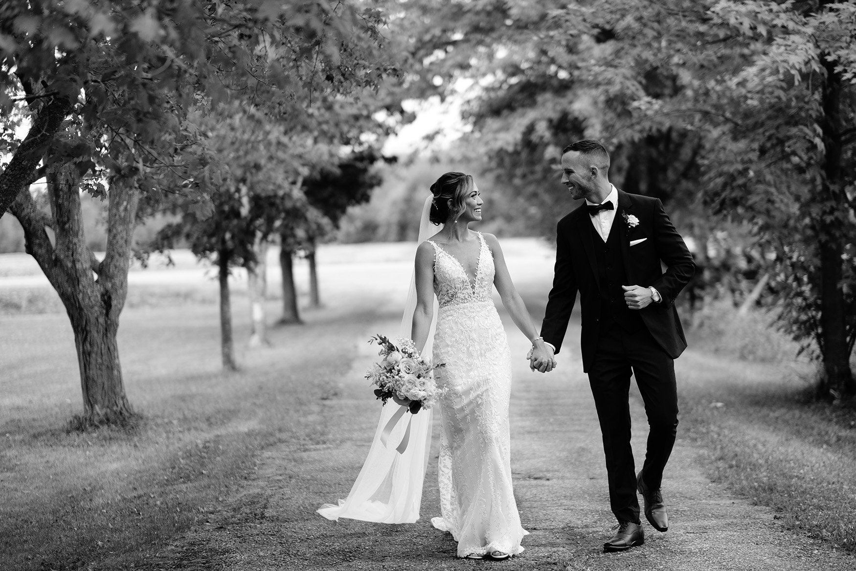 timeless wedding photo of a bride and groom walking down the road at a wedding at evermore in almonte ontario (Copy)