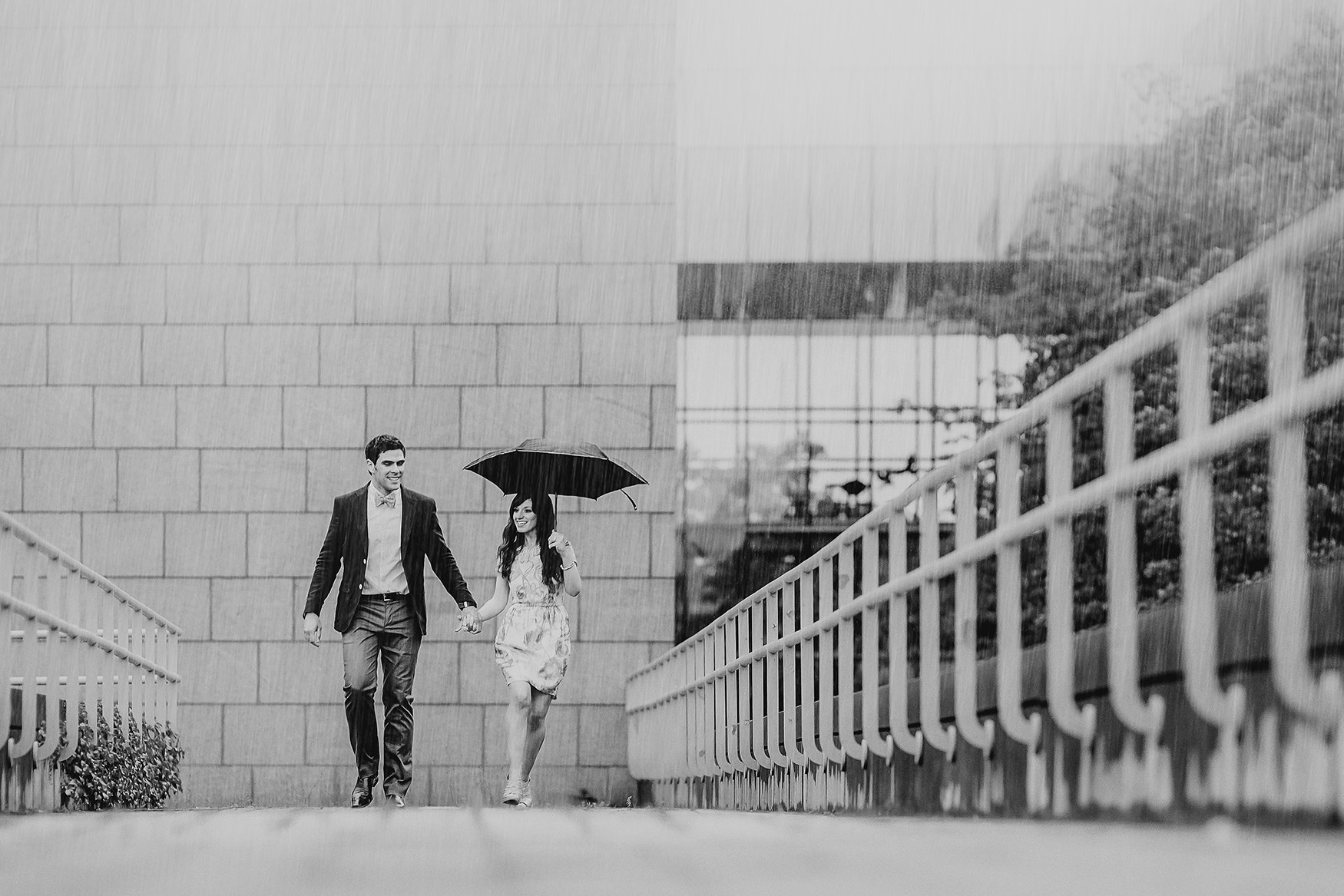 photo of an engaged couple running from the rain outside national gallery of canada in ottawa (Copy)