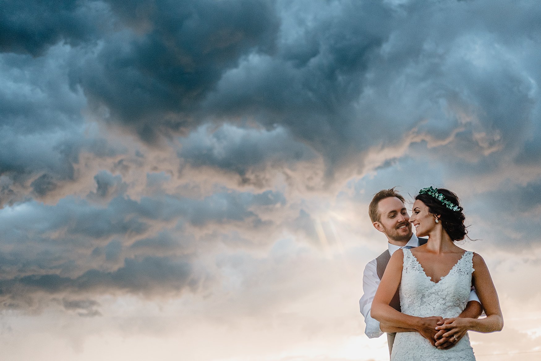 Photograph of a couple on their wedding day in front of an incredible sky (Copy)