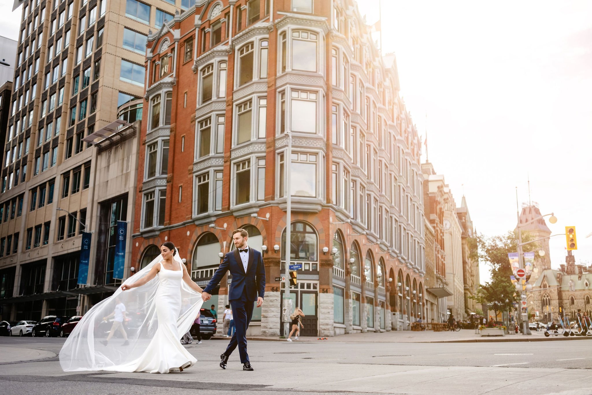 photograph of a bride and groom outside the National Arts Centre (NAC) at sunset