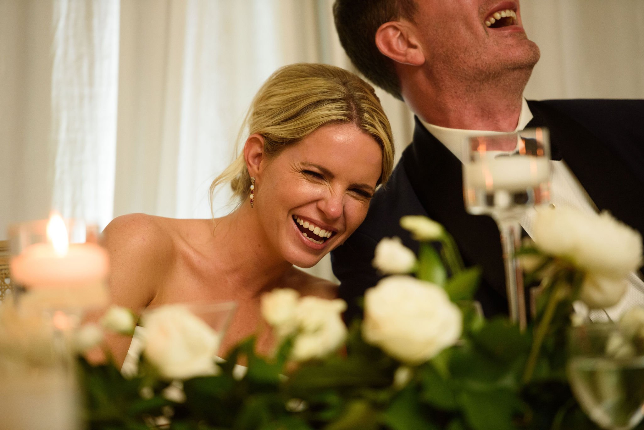 photograph of a bride and groom laughing