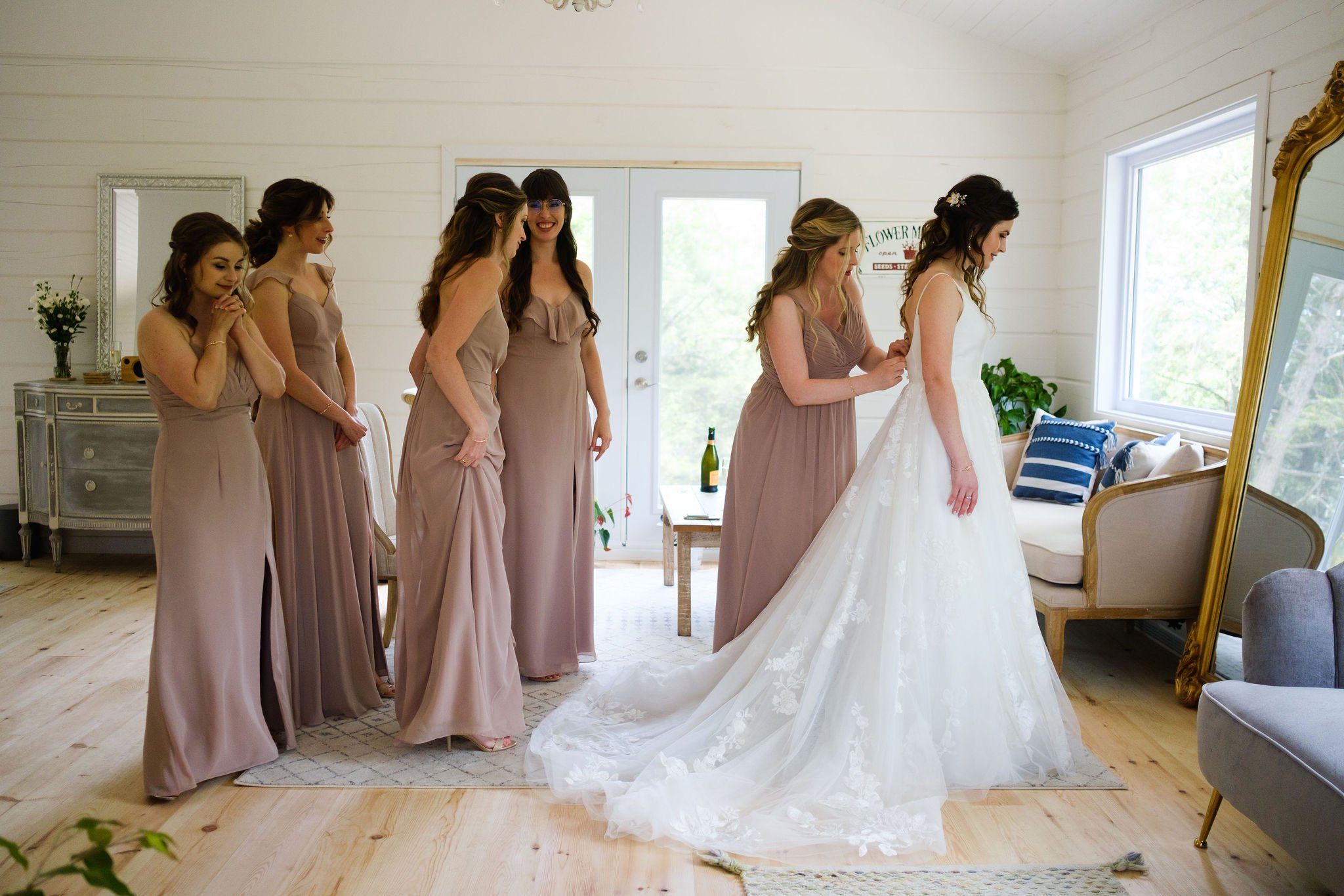  photo of a bride getting into her dress at le belvedere 