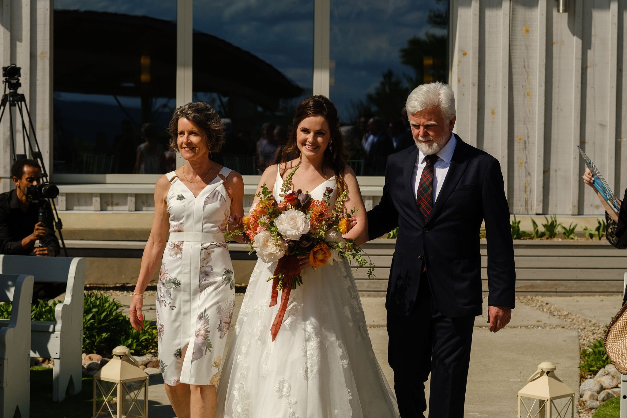  photograph of a bride walking down the aisle at le belvedere 