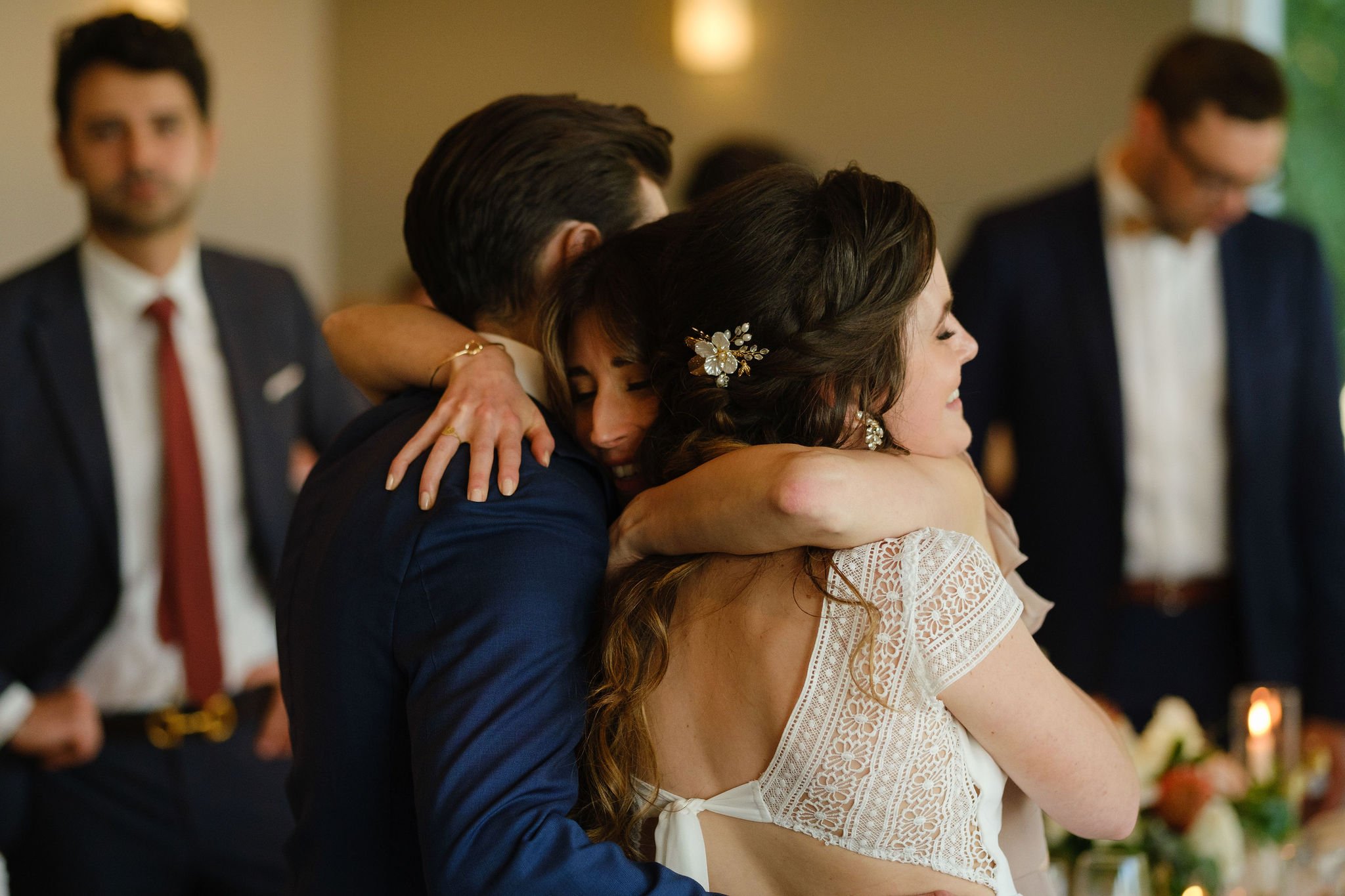  people hugging at a wedding 