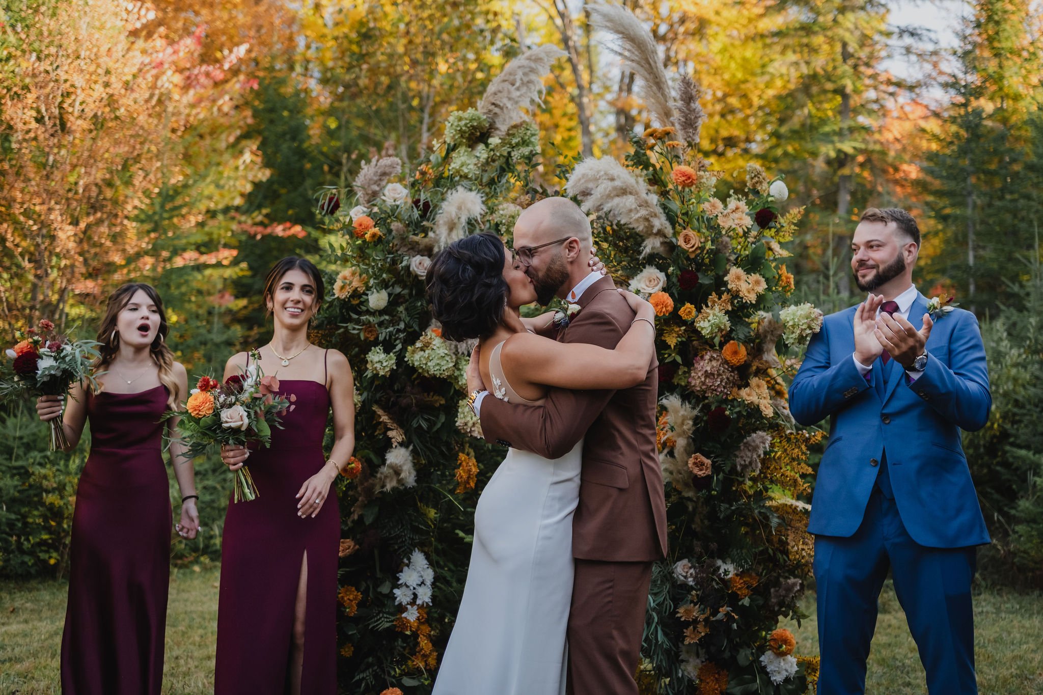 first kiss at an outdoor intimate wedding ceremony