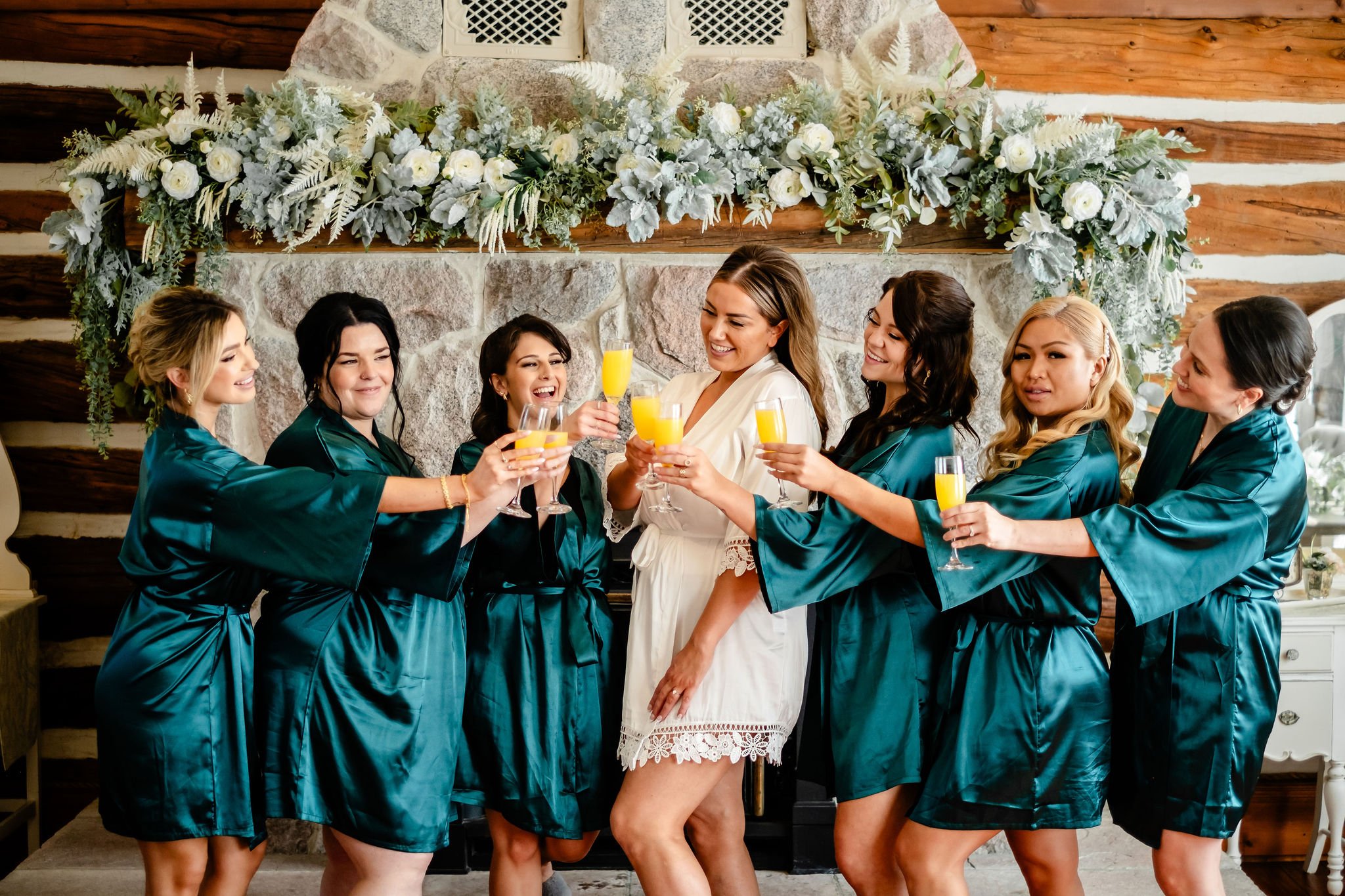 bridesmaids popping champagne before a wedding