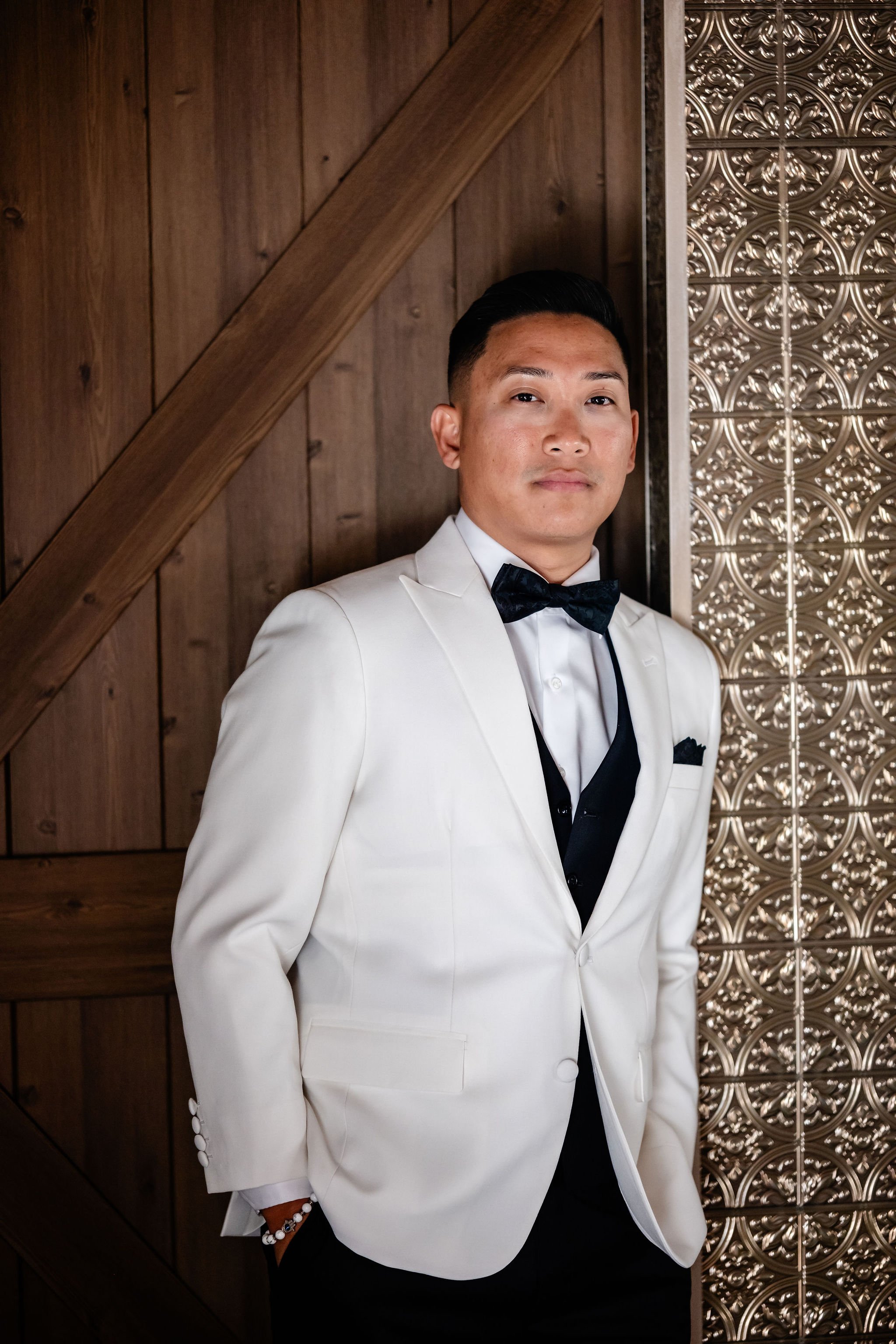 photo of a groom in a white tux