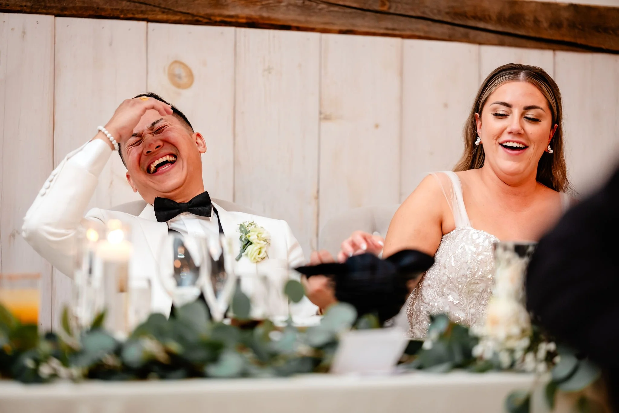 bride and groom reacting to a wedding speech 