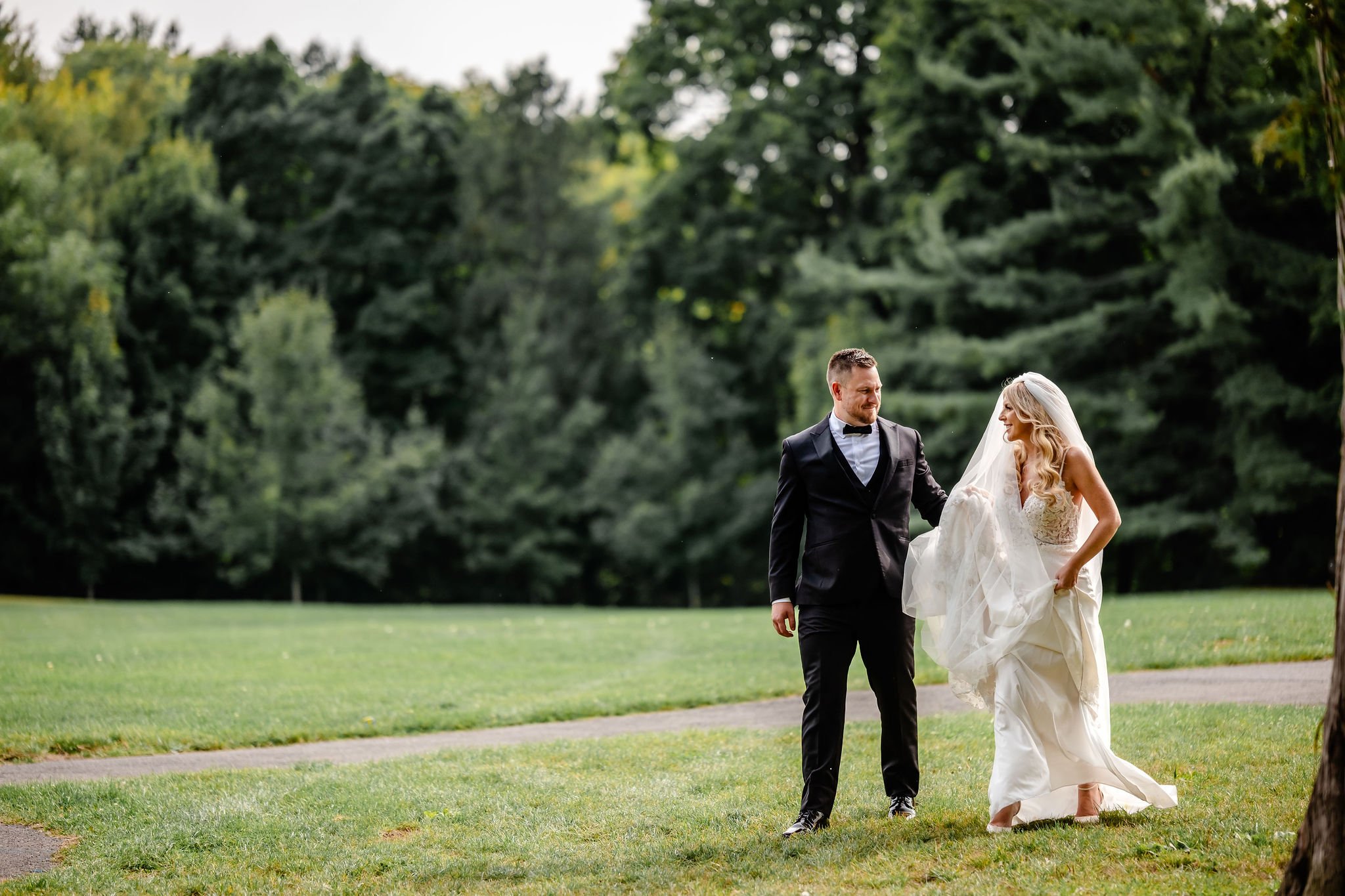 a bride and groom on their wedding day in rockliffe park in ottawa