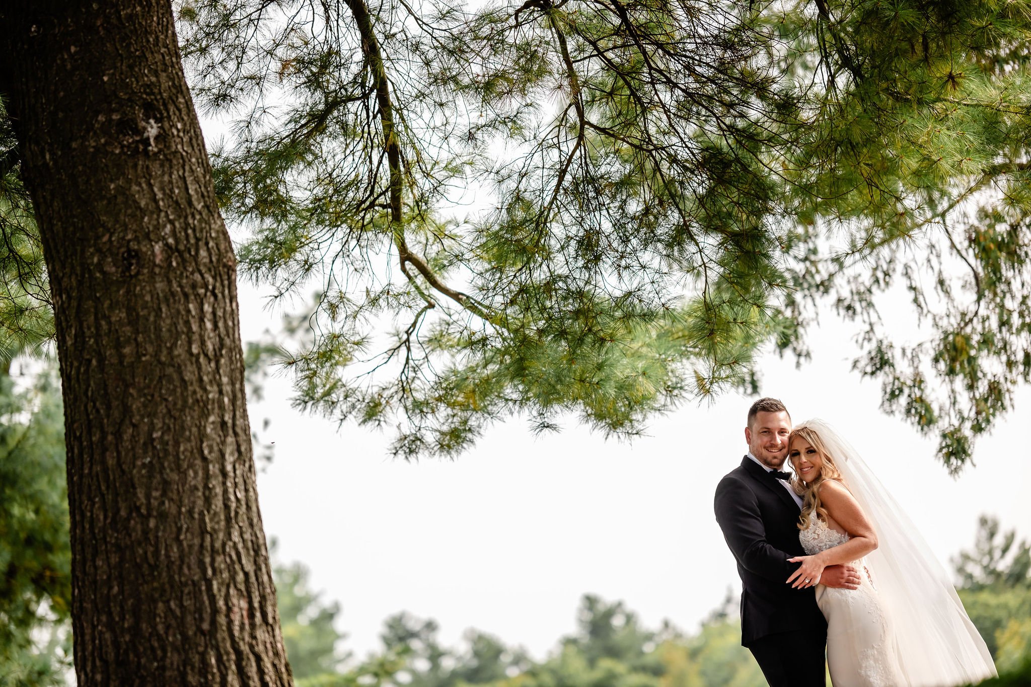 a bride and groom on their wedding day in rockliffe park in ottawa