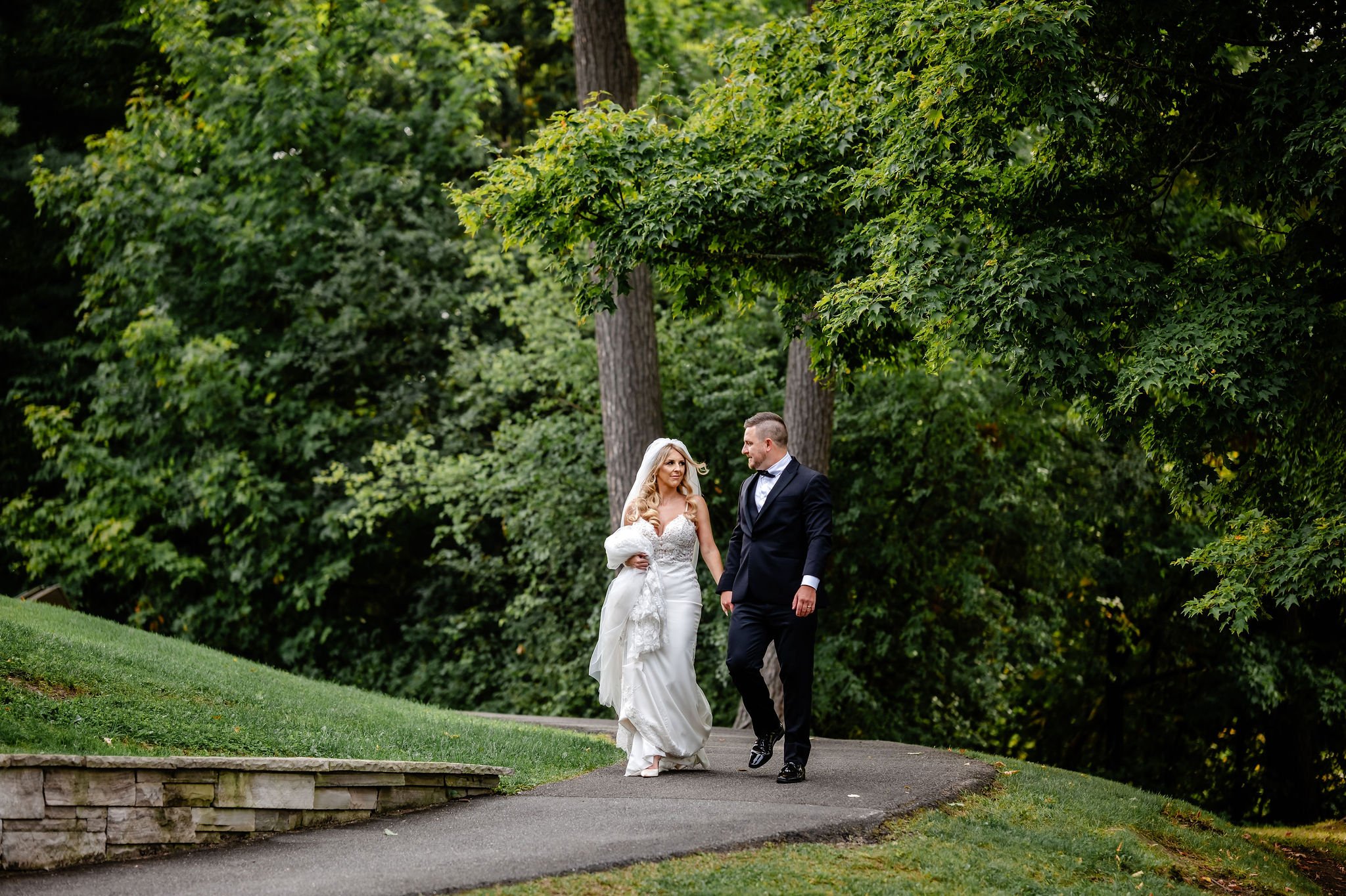 a bride and groom on their wedding day in rockliffe park in ottawa