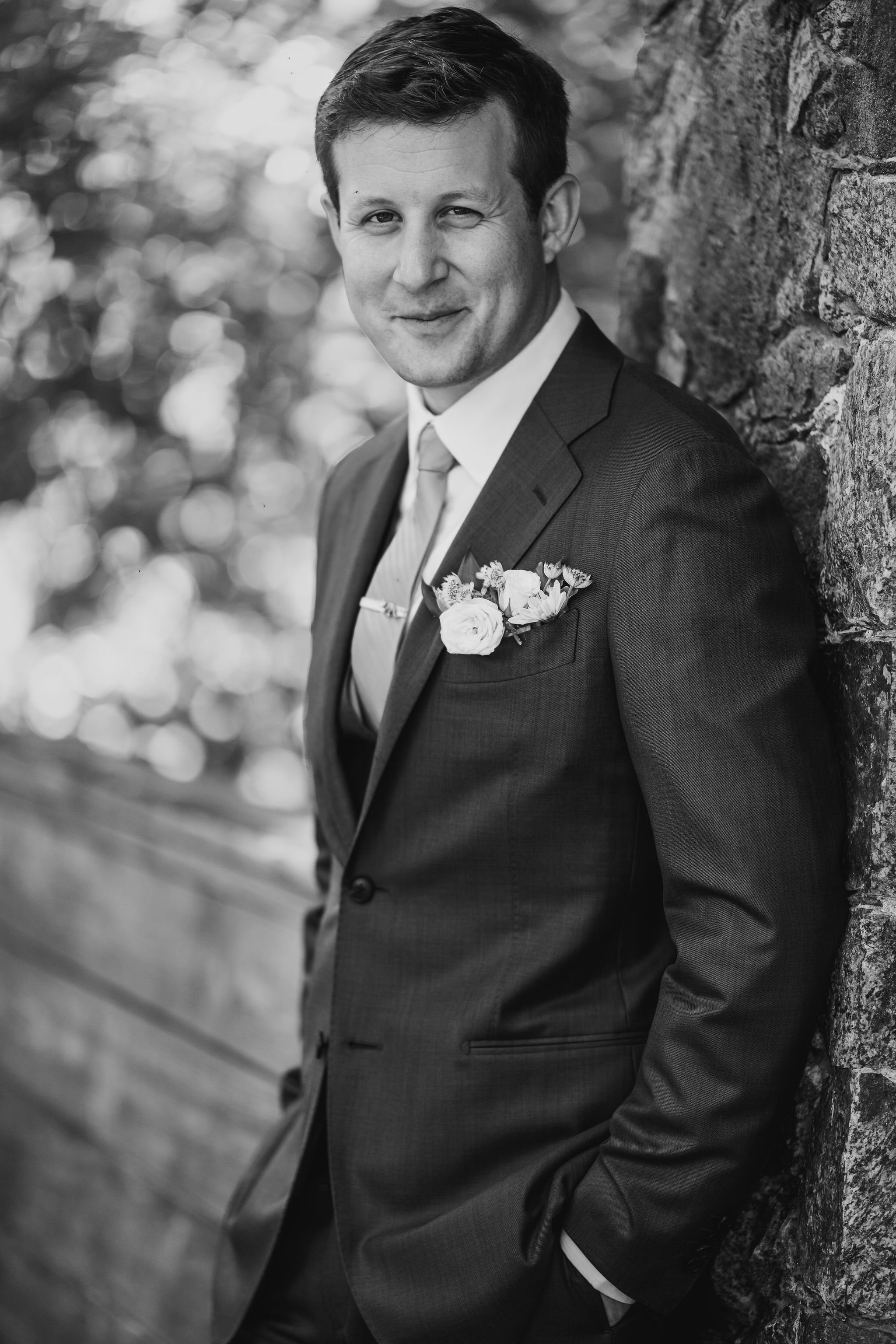 black and white photograph of a groom on his wedding day