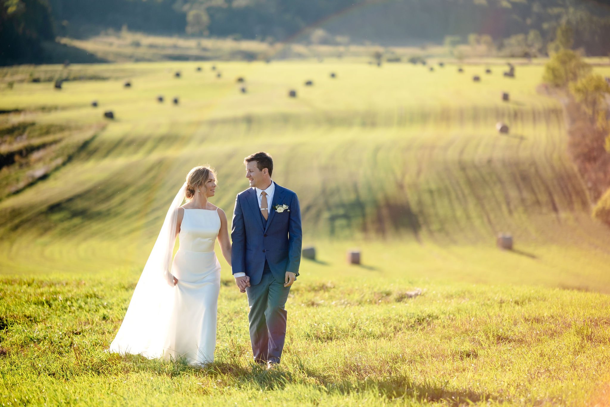 a couple walking hand in hand on their wedding day in Wakefield Quebec