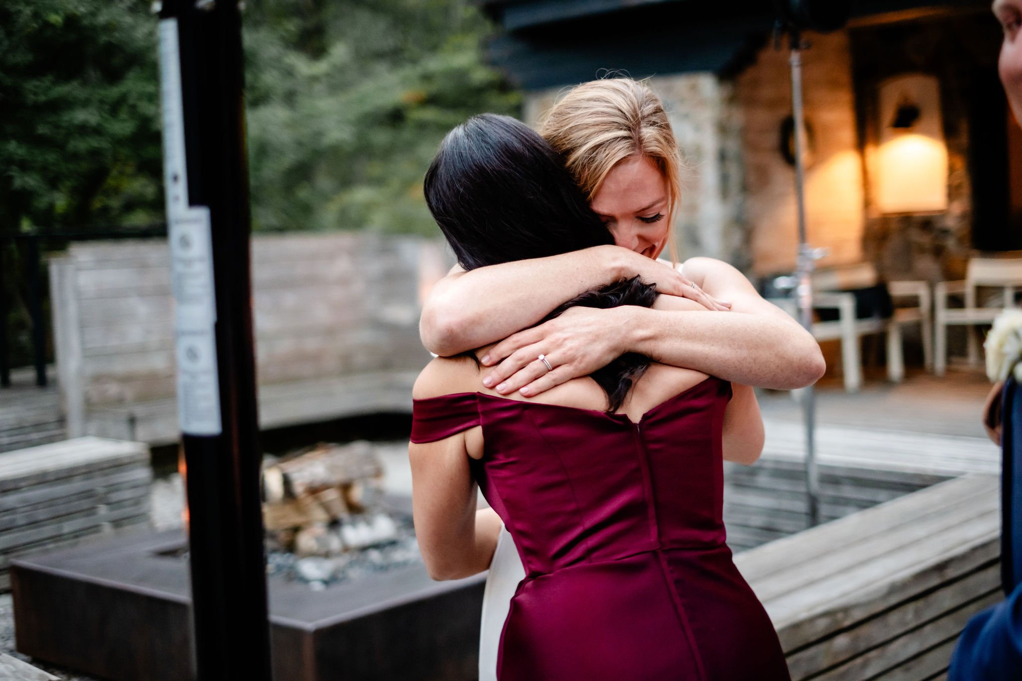 emotional candid photo of  a bride hugging her friend