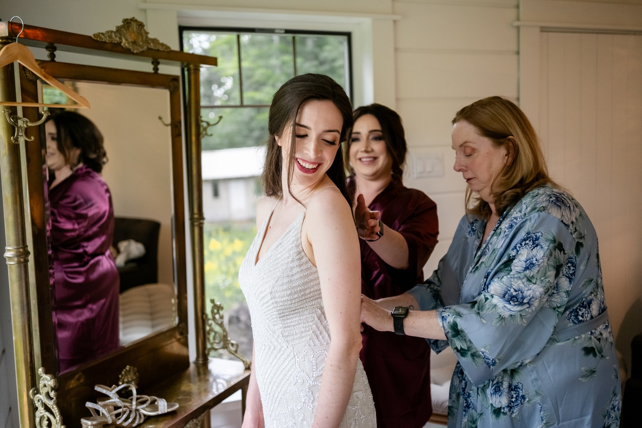 photo of a bride getting into her wedding dress at le belvedere