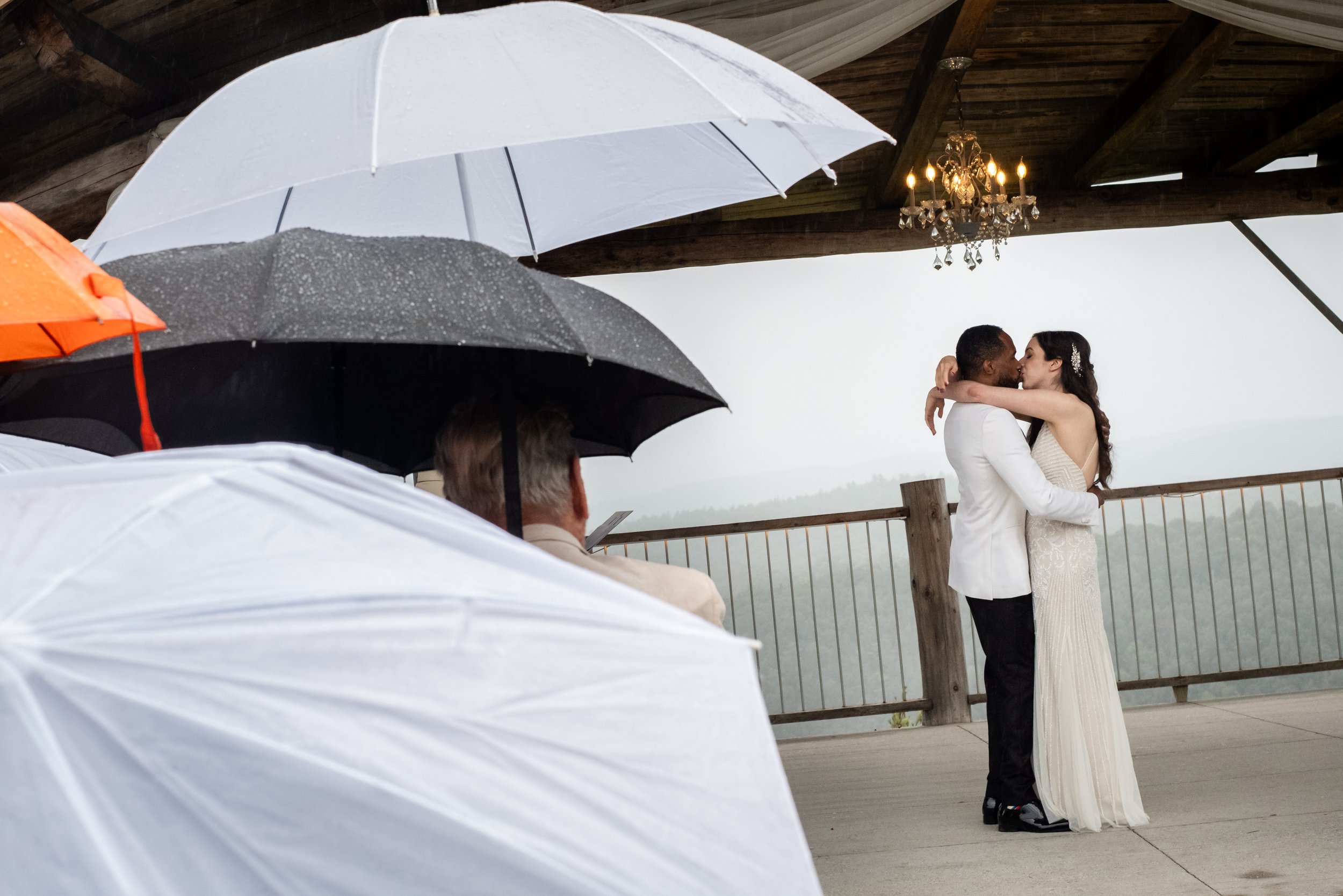 first kiss at a rainy le belvedere wedding
