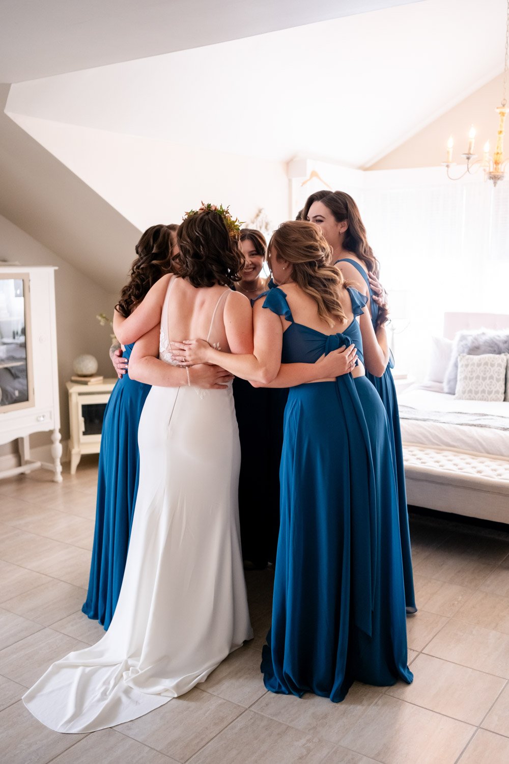 photo of bridesmaids reacting to seeing the bride in her wedding dress for the first time.
