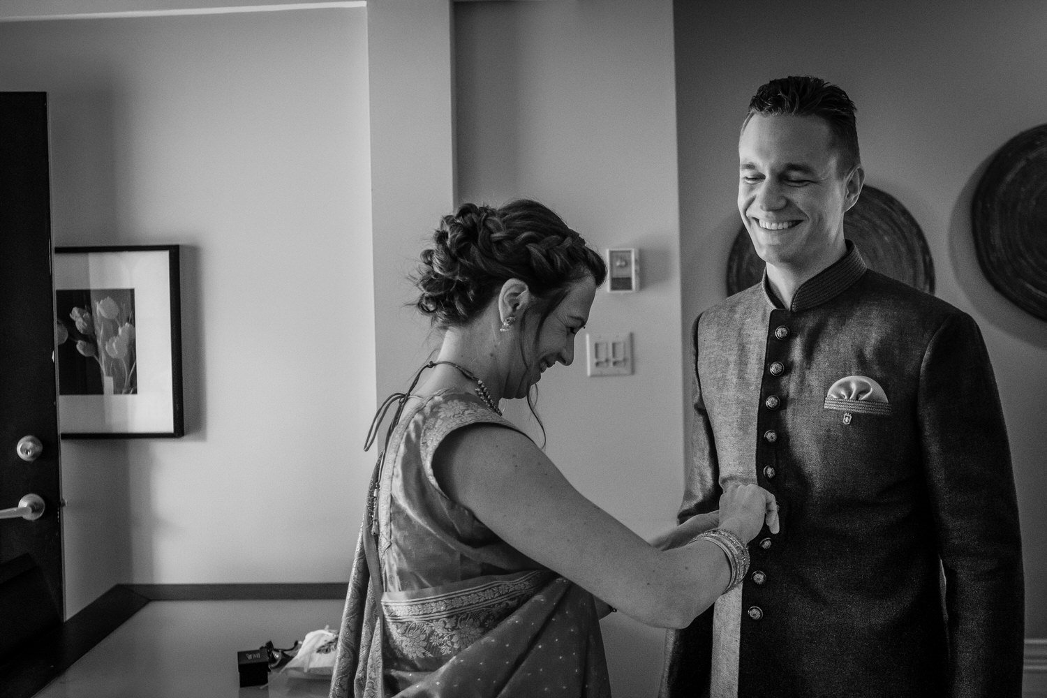 black and white photo of a groom getting ready for his wedding