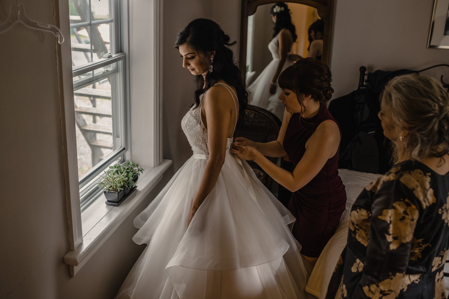a bride getting into her wedding dress