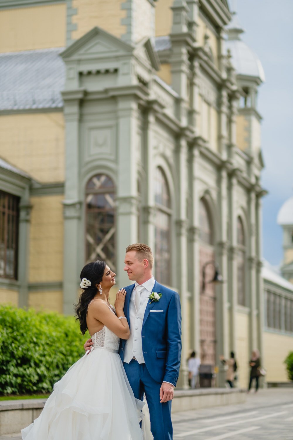 wedding portrait outside the horticulture building with the cattle castle in the background