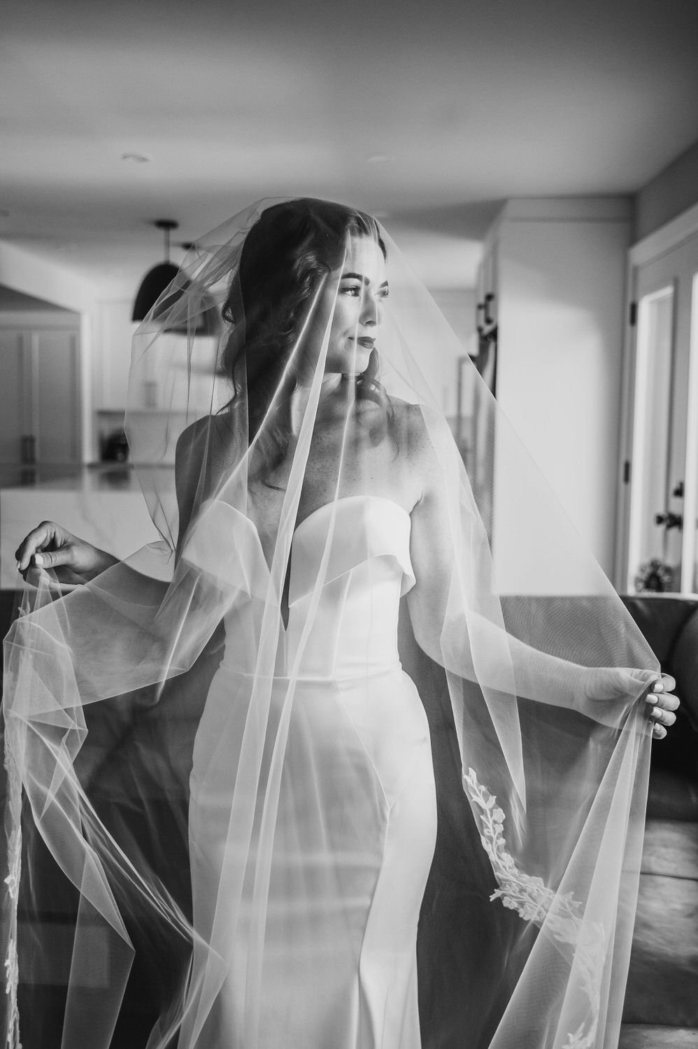 black and white photograph of an elegant bride in her wedding dress