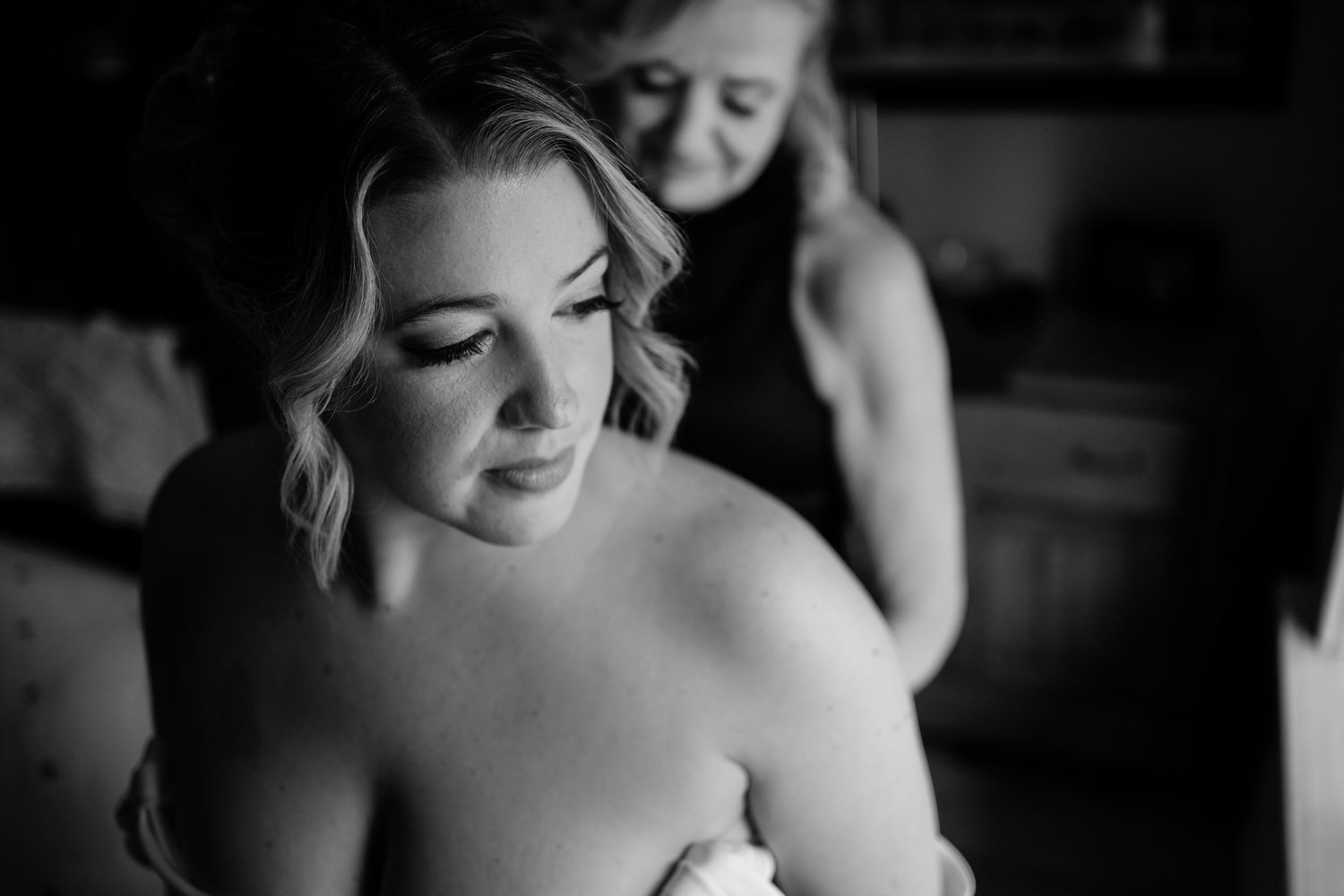 a photo of a bride getting into her wedding dress