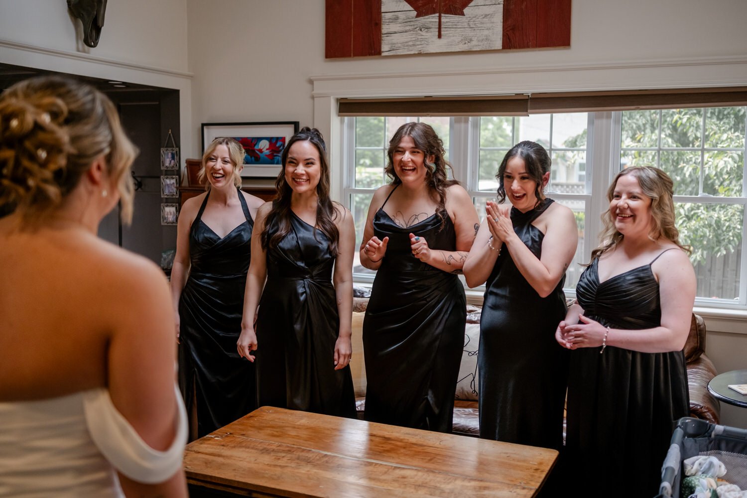 a bride doing a wedding dress reveal with her bridesmaids