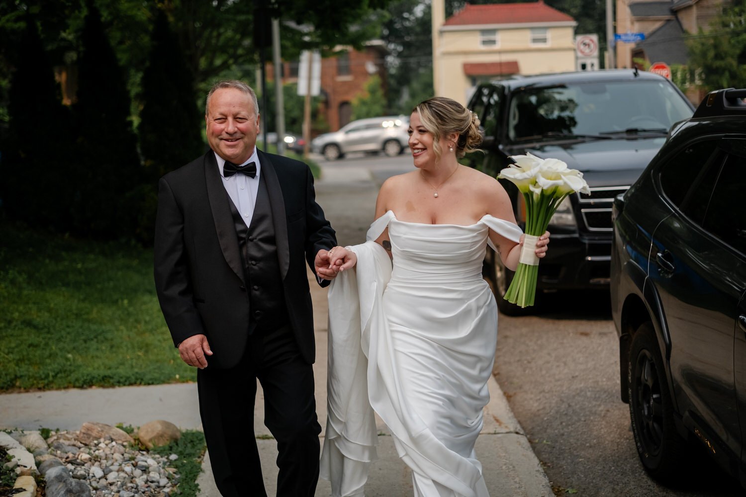 a bride walking to her wedding ceremony with her father