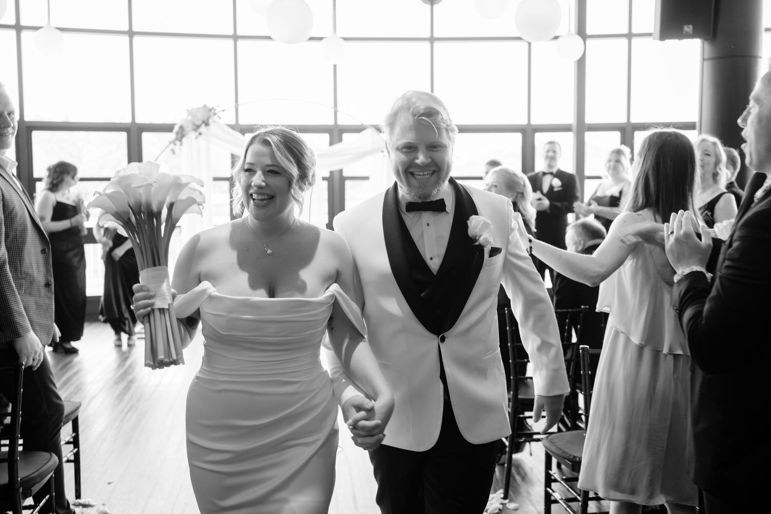 bride and groom walking back down the aisle at Lago in ottawa
