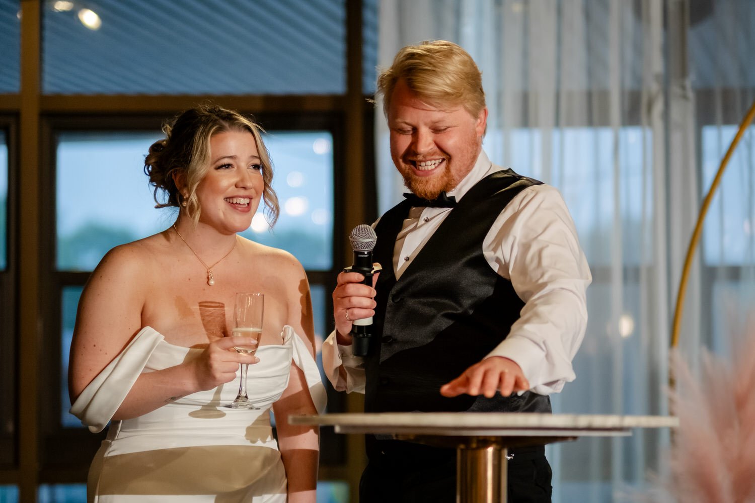 a photo of a couple giving a speech at their wedding reception at Lago