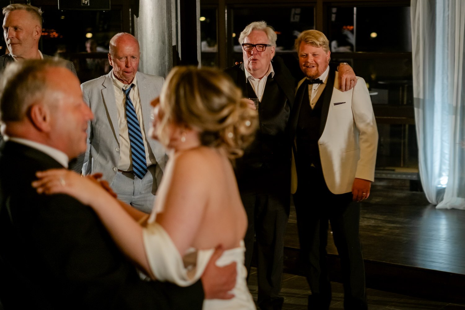 a father dancing with his daughter at her wedding
