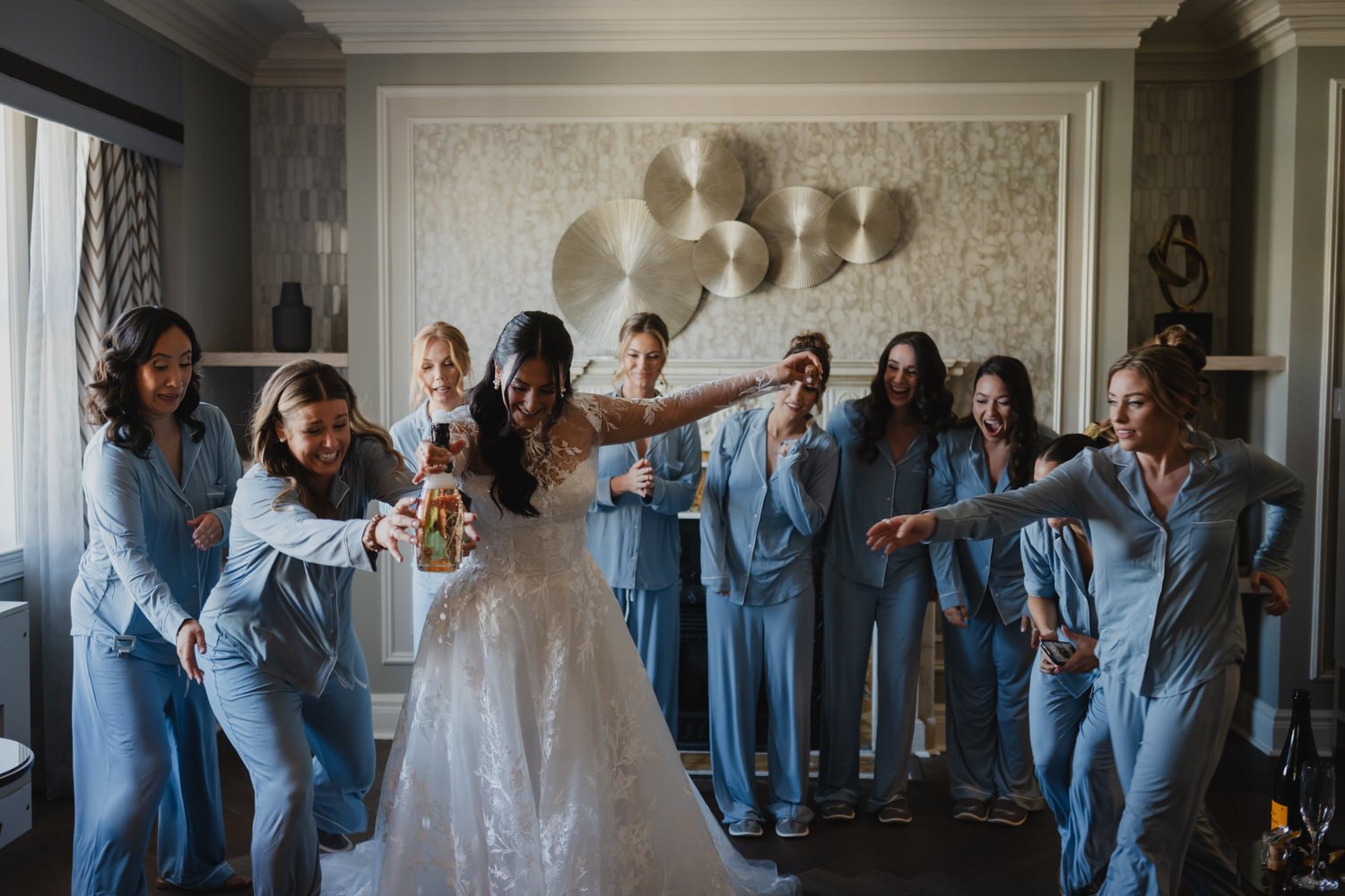 bride popping a champagne cork