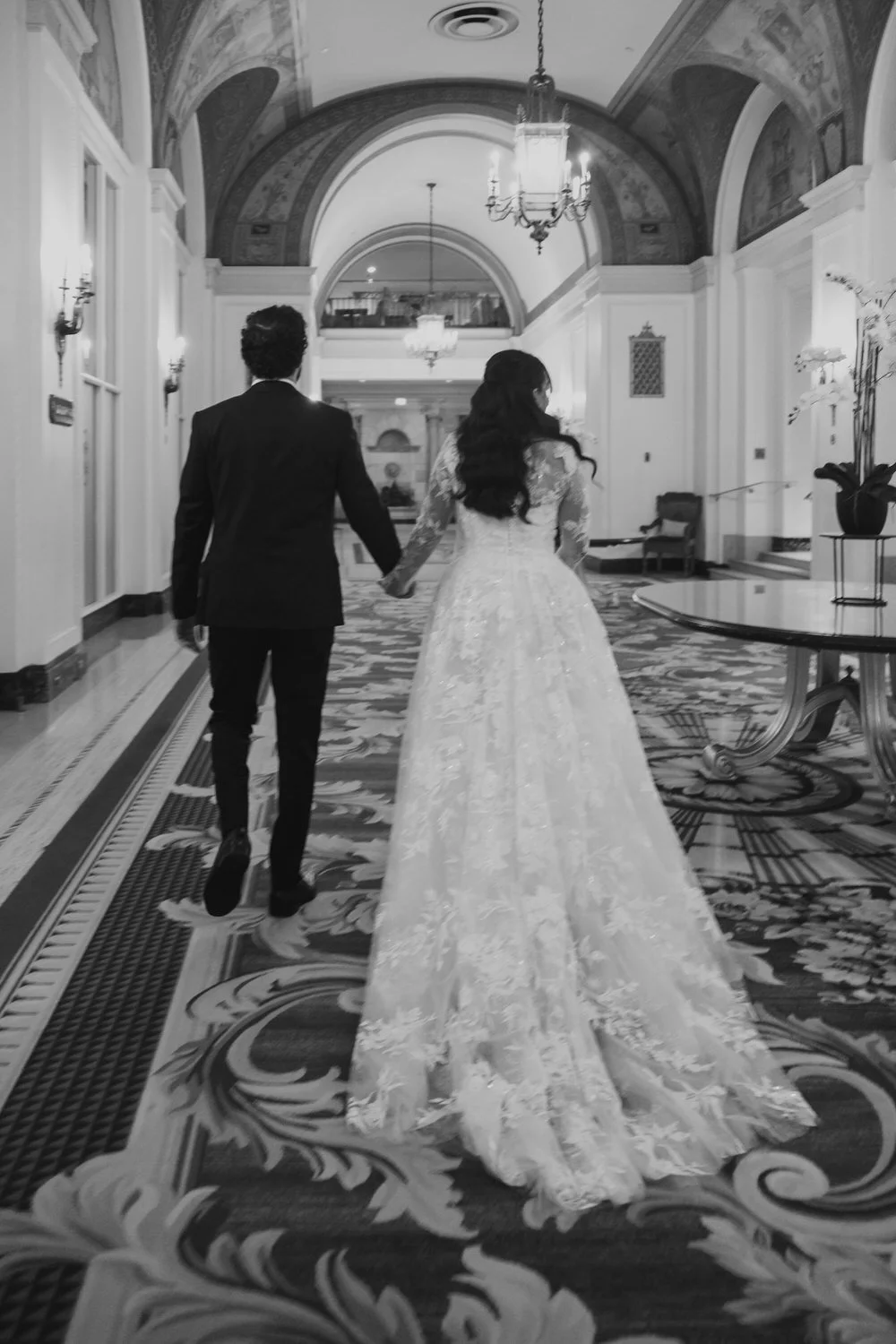 wedding couple walking through the chateau laurier