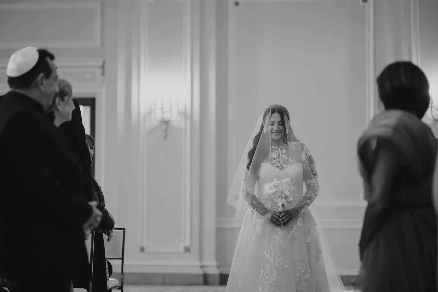 a bride walking down the aisle in the drawing room at a chateau laurier wedding