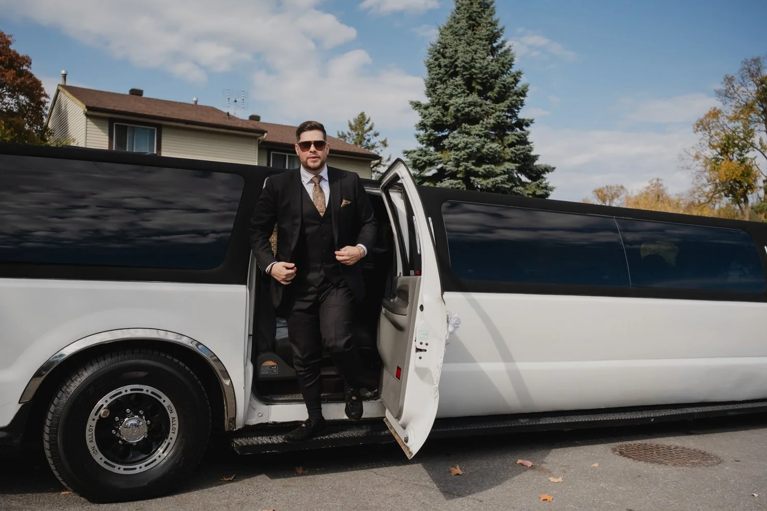 a groom getting out of a limo