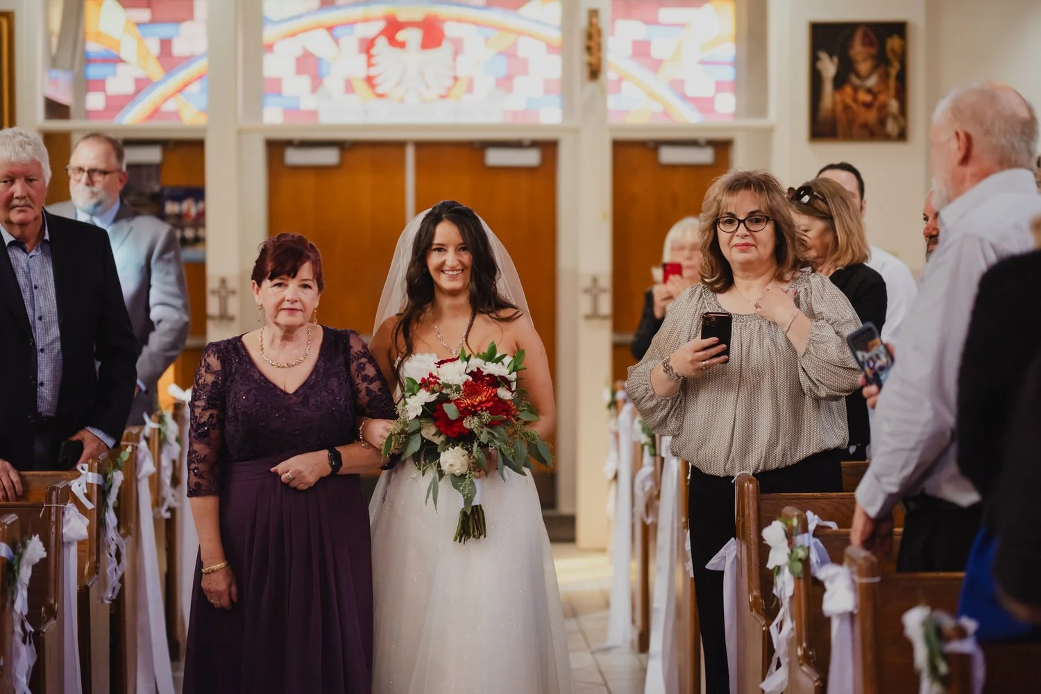 a bride walking down the aisle in an ottawa church