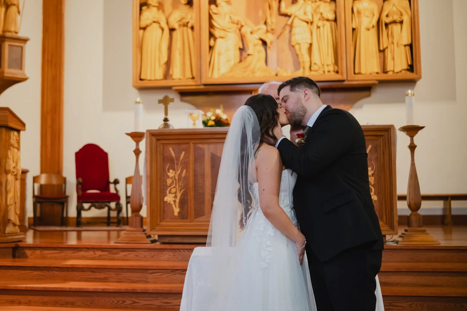 first kiss at a wedding ceremony photograph in a traditional ottawa church