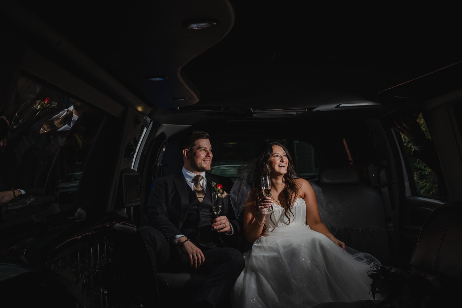 photo of a bride and groom inside a limo