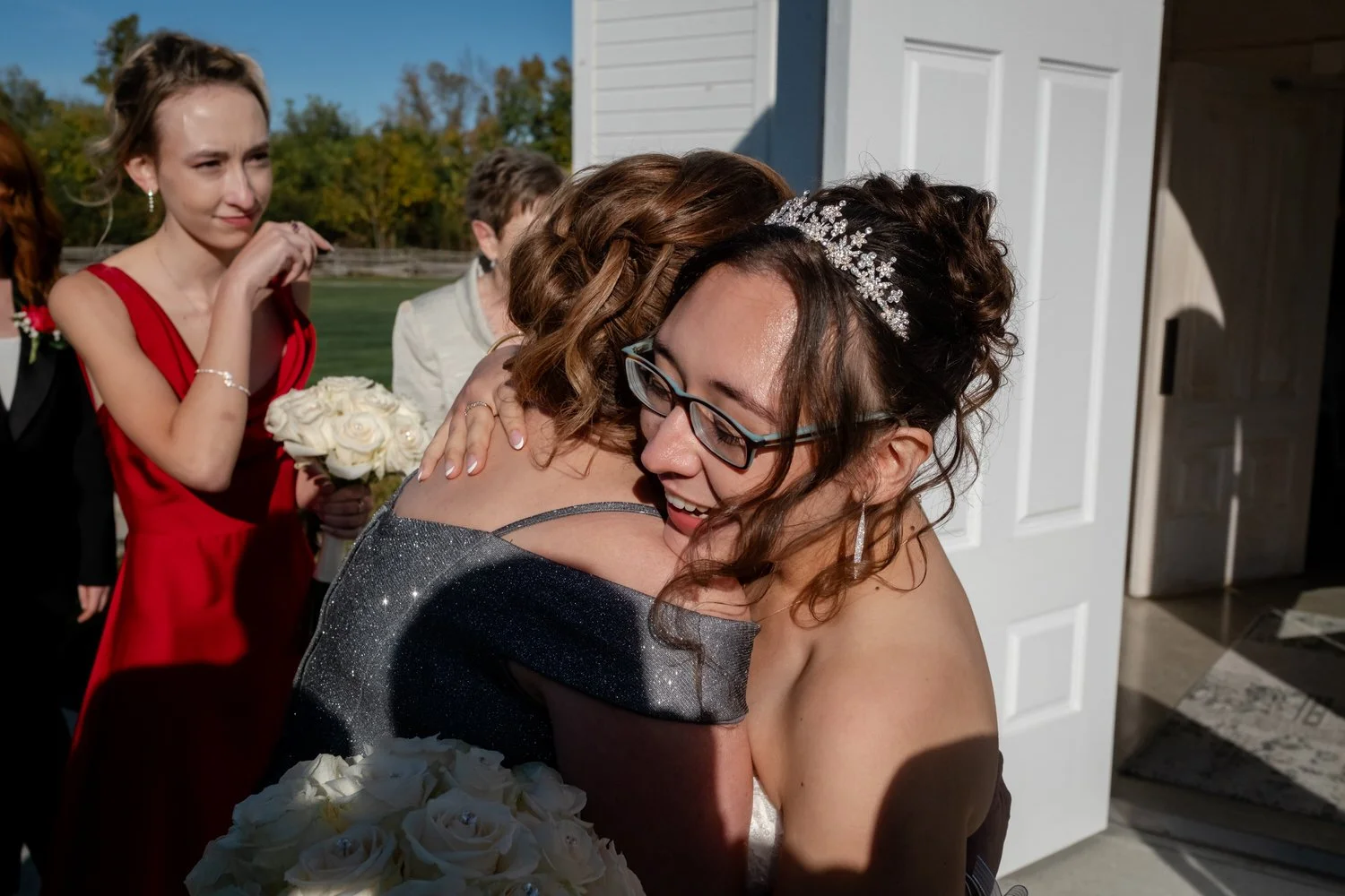 family members hugging a celebrating after a wedding ceremony