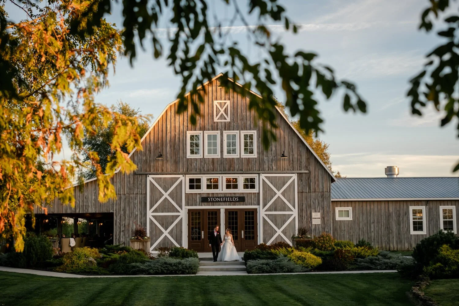 photo of a married coupe in front of stonefields estate at sunset