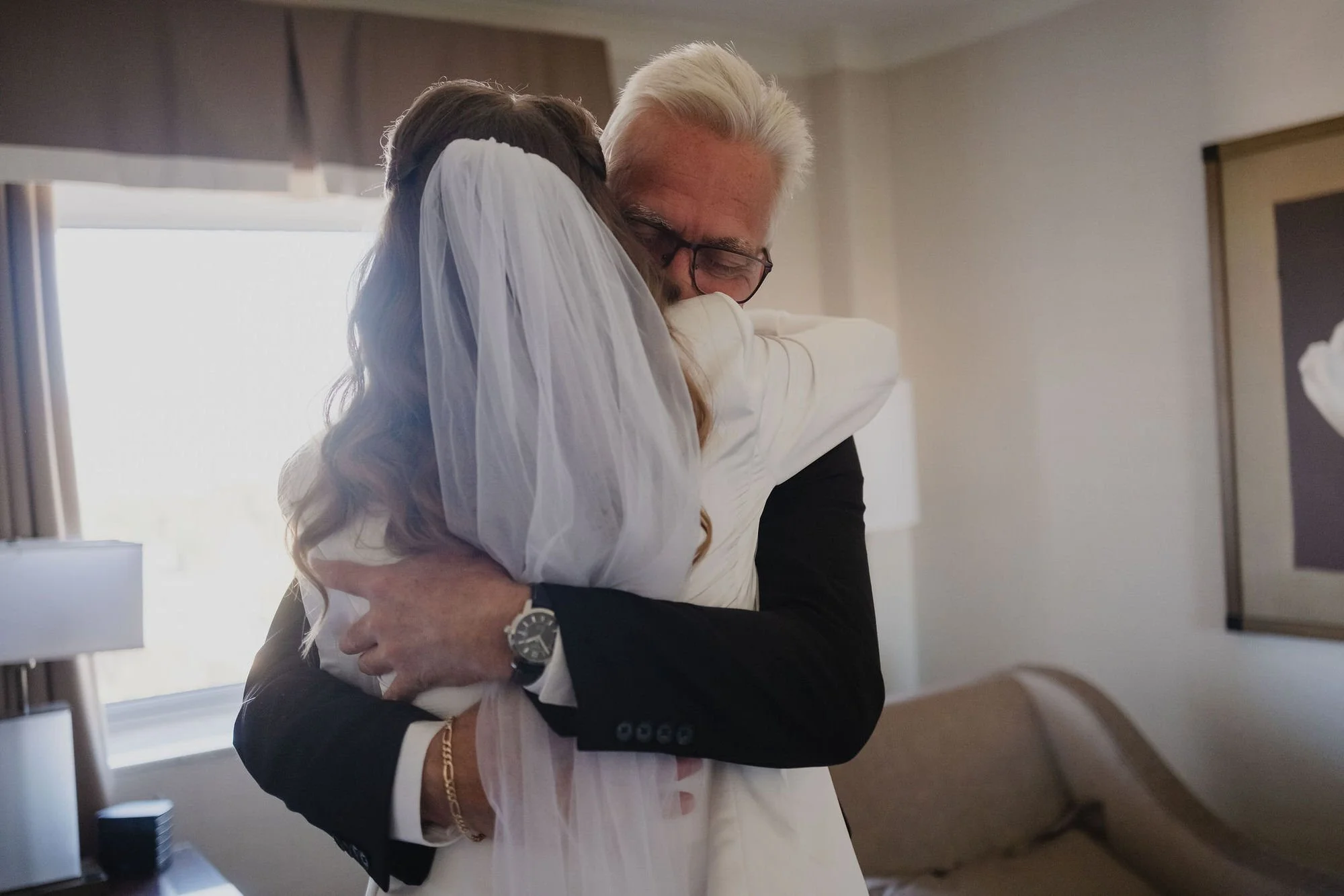 photo of an emotional embrace between a bride and her dad