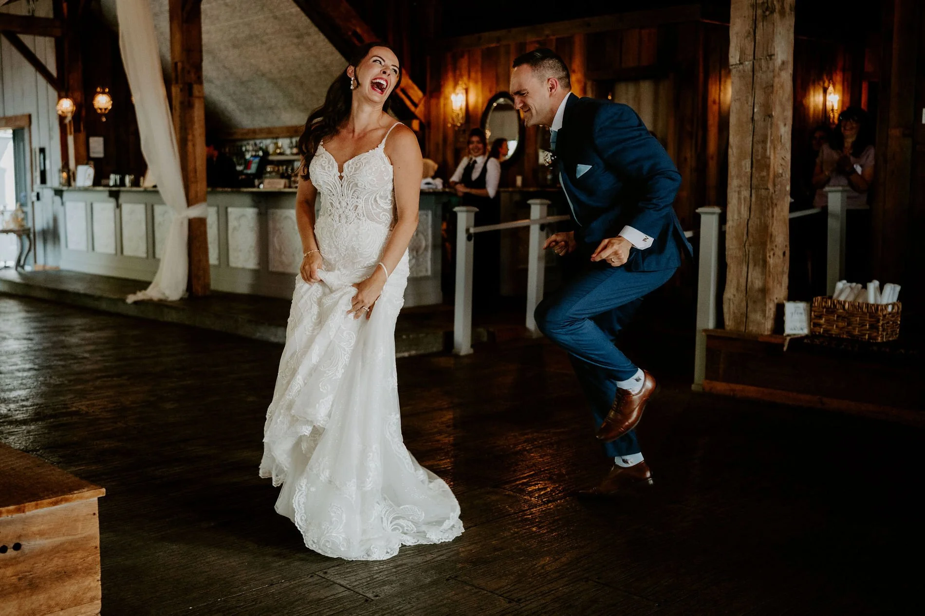Holly laughing as Petar dances across the barn floor at Evermore